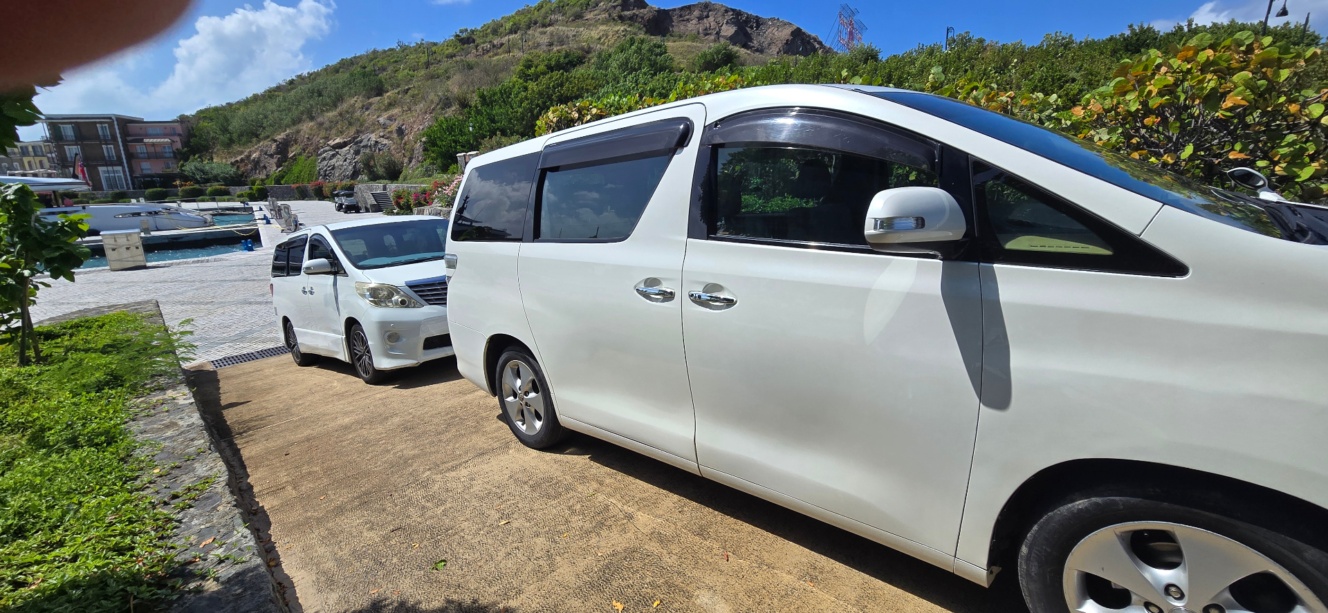 SVG Yacht Services VIP transfer vans waiting at a Grenadines marina
