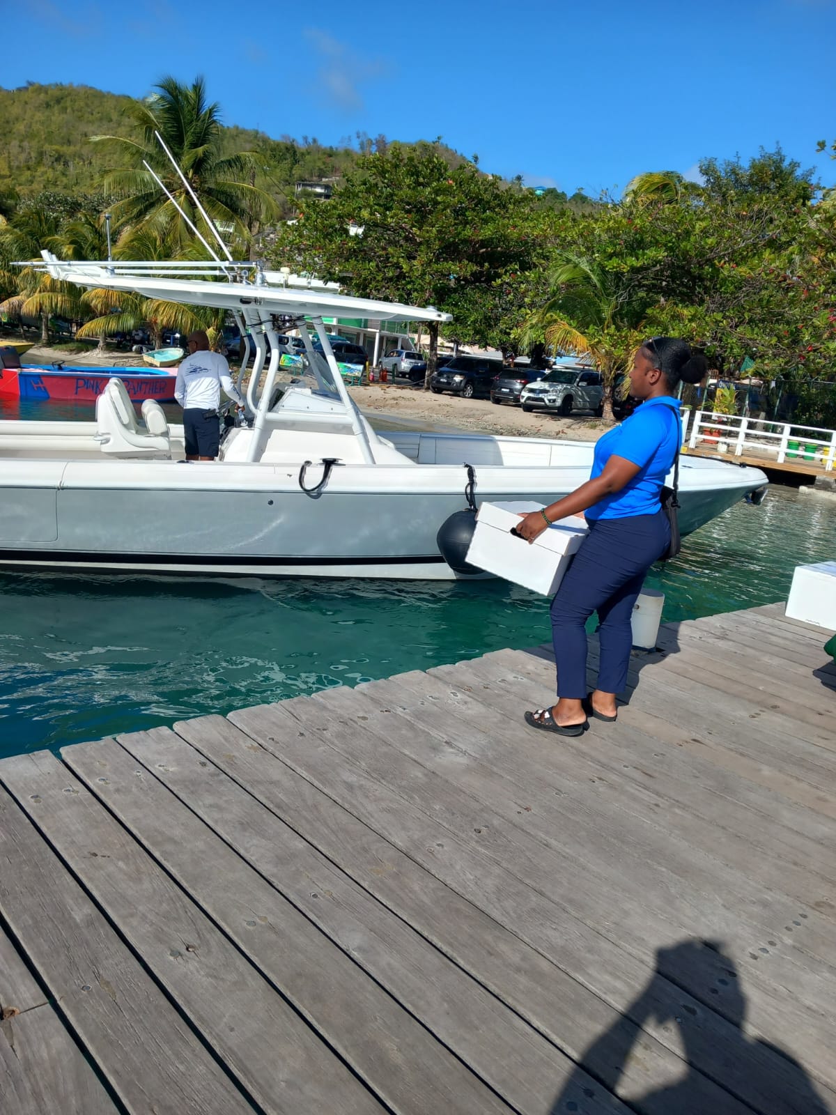 SVG Yacht Services agent handing a delivery to a captain on a sportfisher