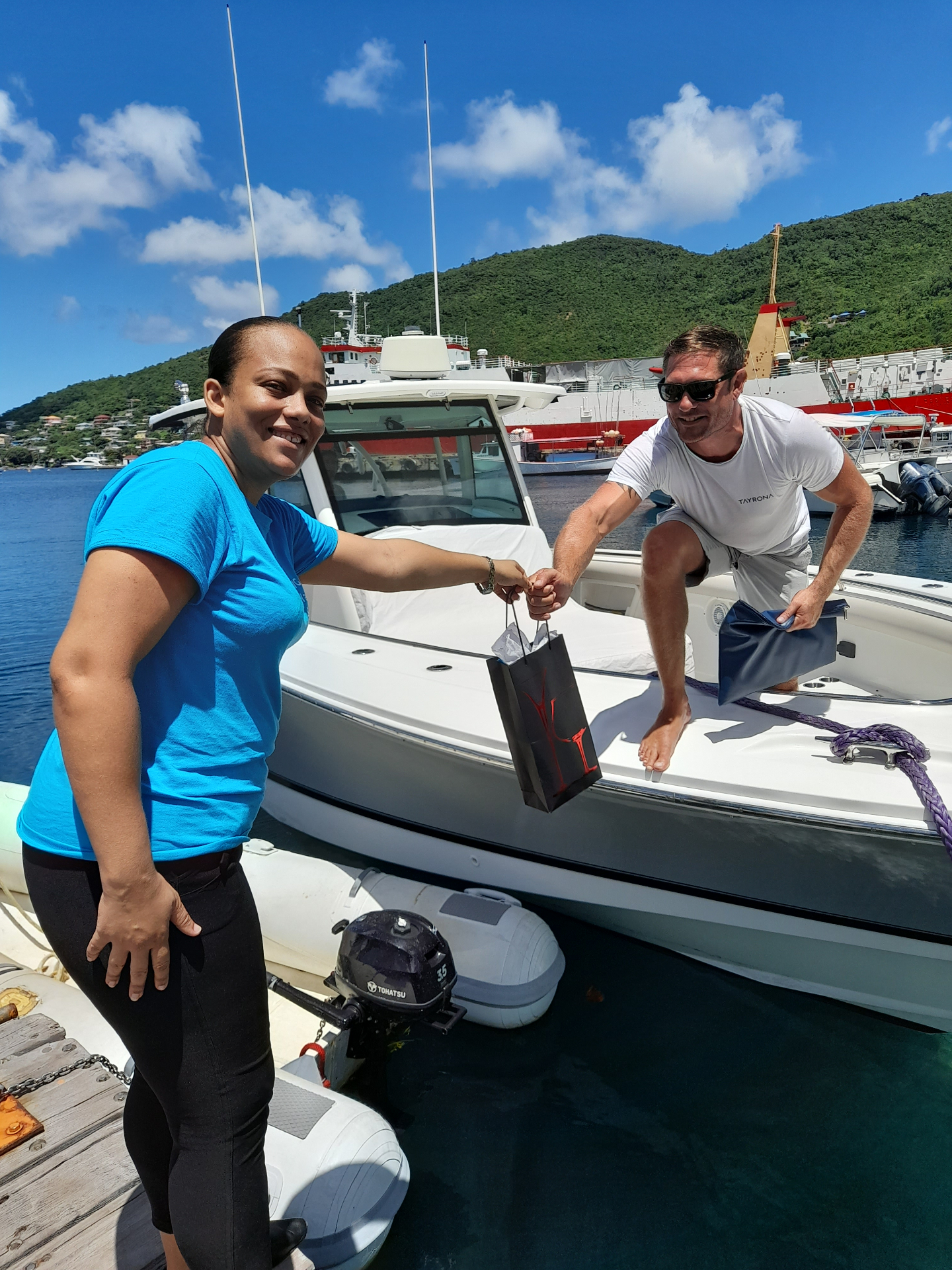 Guest gift handed to a yacht tender at the dock in Bequia